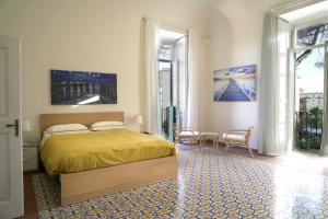 a bedroom with a bed and a table and chairs at Villa Ulisse in Ercolano