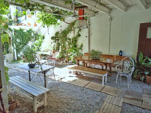 a patio with a table and chairs and a bench at Marakasa B&B in Sant Antoni de Calonge