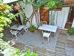 a patio with a table and chairs in a garden at Marakasa B&B in Sant Antoni de Calonge