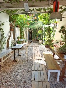 an outdoor patio with a table and benches at Marakasa B&B in Sant Antoni de Calonge