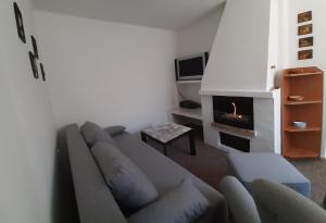 sala de estar con sofá y chimenea en SAUNA Dom, en Pezinok