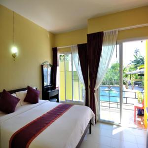 a bedroom with a bed and a large window at Serene Villa Phuket in Chalong 