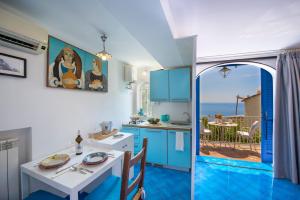 a kitchen and dining room with a view of the ocean at Casa Bellina in Positano