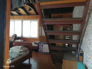 a room with a bunk bed and a staircase at Aghrougolok Hostel in Lida