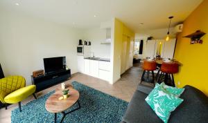 a living room with a couch and a table at Sunny 45m2 Penthouse with Balcony and Terrace in Eindhoven