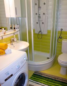 a bathroom with a shower and a washing machine at Apartments Klementina in Postira