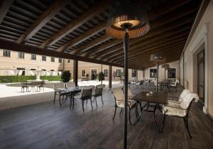 a patio with tables and chairs and a ceiling at Château Šanov in Šanov
