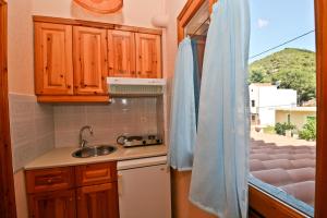 a kitchen with a sink and a window at Korinas House in Agnontas