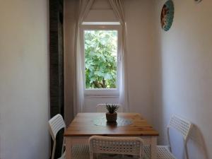 a table and chairs in a room with a window at Studio apartment Vigo - Rijeka in Rijeka