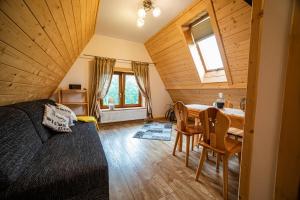 a bedroom with a bed and a table in a room at Apartament Stary Mlyn in Zakopane