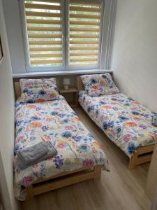 Posteľ alebo postele v izbe v ubytovaní Stara Piekarnia - Apartament Dworcowa
