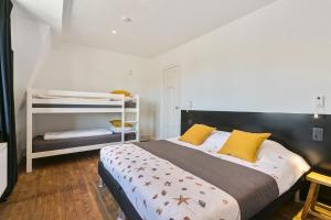 a bedroom with a large bed with yellow pillows at Maison Clos in De Panne