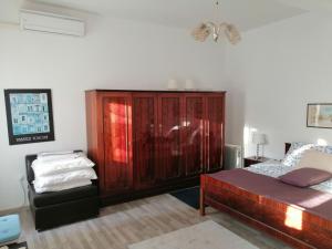 a bedroom with a bed and a wooden cabinet at Holiday Home Peruski in Peruški +25 photos