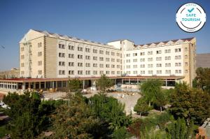 a large building with a courtyard in front of it at Dinler Hotels Urgup in Ürgüp