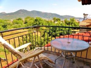 a balcony with a table and two chairs on a balcony at Barbara Studios in Skala Potamias