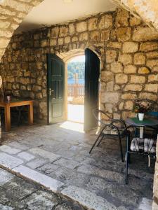 an entrance to a stone building with a table and chairs at Sobe More Cavtat in Cavtat