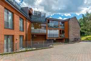 a brick building with balconies on the side of it at Gustav Apartments - City Center Comfort in Tartu