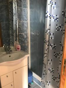 a bathroom with a shower curtain and a sink at Apartmani Vilma Pakoštane in Pakoštane +49 photos