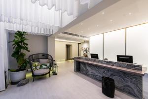 a lobby with a reception desk and a chair at Kaya Heritage Hotel in Bangkok +52 photos
