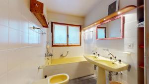 a bathroom with a sink and a toilet and a tub at Beautiful apartment in the center of Crans-Montana with a large balcony in Crans-Montana +10 photos