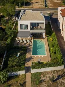 an aerial view of a house with a swimming pool at Villa Lu-Ma Beachfront with Heated Pool in Turanj