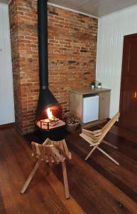 a living room with a brick wall and a fireplace at Pousada Natal Encantado in Gramado