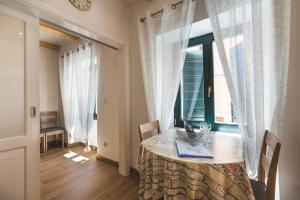 a dining room with a table and a window at VINEA APARTMANI UMAG, Ulica G Garibaldia 2 in Umag