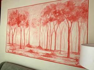 a painting of a forest on a wall at Ritual Sevilla Suites Alameda 1 in Seville