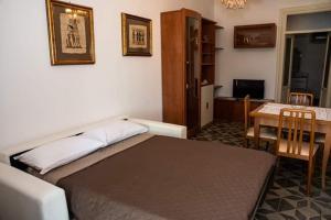ein Schlafzimmer mit einem Bett und einem Tisch sowie ein Esszimmer in der Unterkunft Belvedere in Locorotondo
