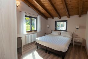 a bedroom with a bed and a window at Er Mirin - Il Mulino di Carcare Hotel in Carcare