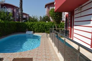 a swimming pool in a yard next to a building at Antalya belek private villa private pool 4 bedrooms close to beach park - land of legends in Belek