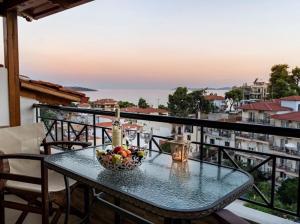 a bowl of fruit on a table on a balcony at Anna Maria Views in Neos Marmaras
