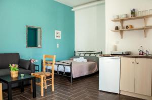 a small room with a bed and a table at Ag.apostoloi studios in Agioi Apostoli