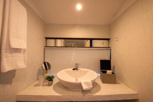 a bathroom with a sink with a towel on it at Quinta da Malaposta - Boutique Hotel & Eventos in Vila Nova de Cerveira +32 photos