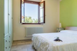Postel nebo postele na pokoji v ubytování Agriturismo La Casina nel Vigneto + 35 fotografií