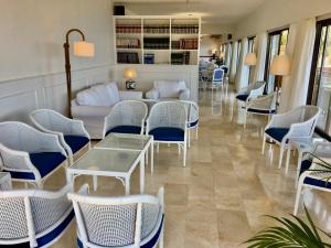 
a room filled with tables and chairs with umbrellas at Hotel Sa Coma in Banyalbufar
