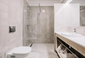 a bathroom with a shower and a toilet and a sink at Green Loft Gdynia in Gdynia
