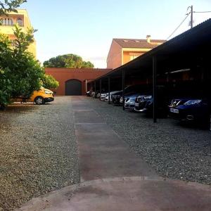 a row of cars parked in a parking lot at Sant Jordi in Montbrió del Camp