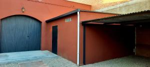 two garage doors on the side of a building at Sant Jordi in Montbrió del Camp