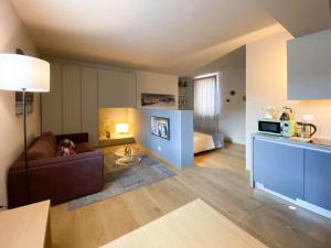 a living room with a couch and a bed at Time to Be - Luxury Apartments Centro Storico in Peschiera del Garda