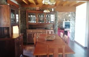 a kitchen with a wooden table and a dining room at Casa con encanto in Cedeira