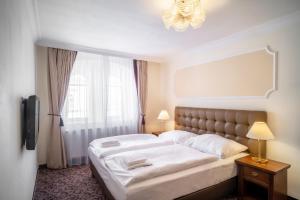 Postel nebo postele na pokoji v ubytování WINDSOR SPA Hotel