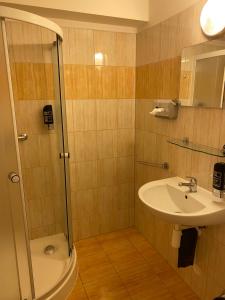 a bathroom with a shower and a sink at Hotel Praděd Rýmařov in Rýmařov