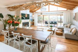 a living room with a wooden table and chairs at Yallingup Valley Retreat in Yallingup
