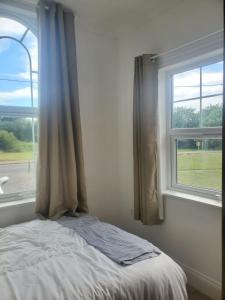 a bedroom with a bed and a window at Grand Norfolk in Mundesley