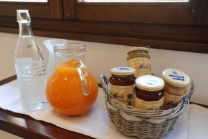 a basket of honey and a bottle of orange juice at Honey Rooms in Rome