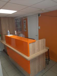 an orange counter top in a room with at Premiere Classe Carcassonne in Carcassonne