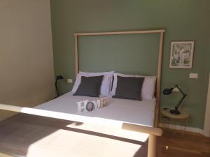a bed with a wooden frame in a bedroom at Via Roma 315 bed and breakfast in Palermo