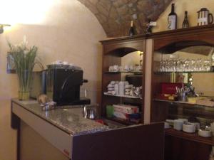 a kitchen with a counter with a coffee maker at Hotel Filippeschi in Orvieto