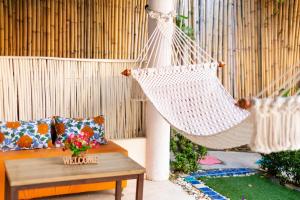 a hammock hanging from a pole in a garden at Palm Coco Mantra in Lamai
